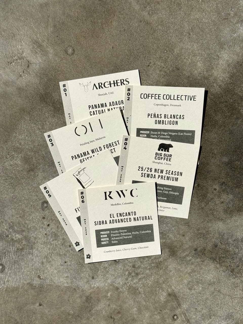 The printed feature cards for a month's six coffees, fanned out